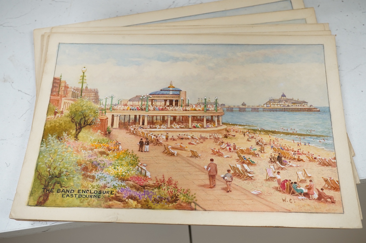 William Affleck, (Aka Carruthers, 1868-1943), a set of seven original watercolours for postcard designs, Eastbourne scenes to include, ‘The Band Enclosure’, ‘The Wish Tower’, ‘Beachy Head’ and ‘The Beach’, each initialle